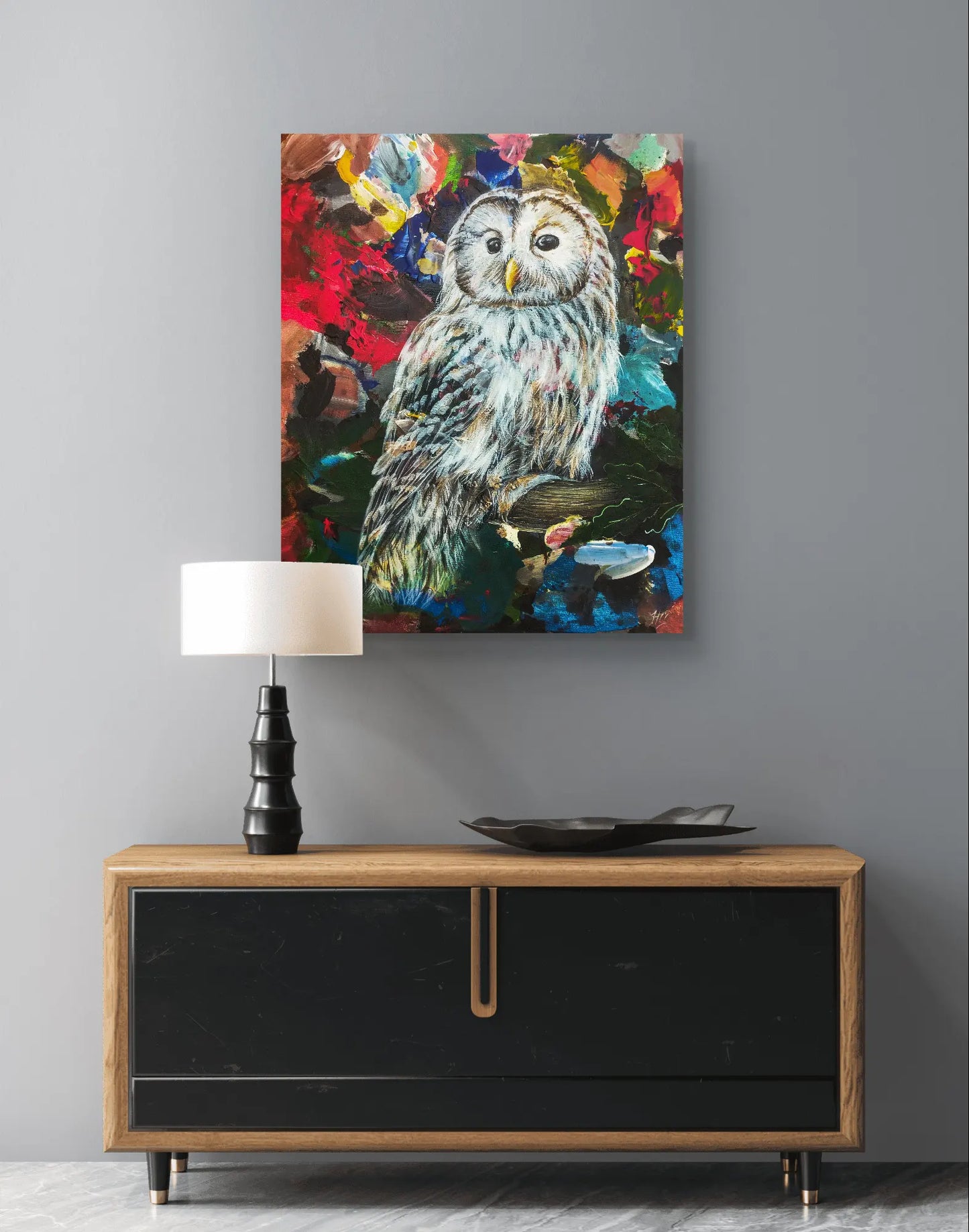 Waldkauz Acrylbild an grauer Wand über modernem Sideboard mit schwarzer Tischlampe