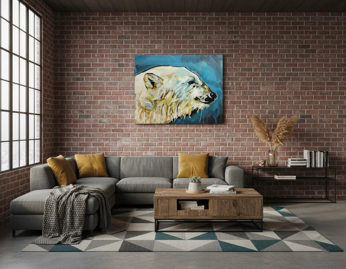 Acrylgemälde Eisbär hängt über einem grauen Ecksofa in einem Loft-Wohnzimmer mit Backsteinwand.